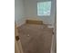 The bedroom includes neutral carpet, a window for natural light, and minimal furnishings at 1415 S Pitkin Ct, Aurora, CO 80017