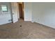 Bedroom showcases neutral carpet, a window, and a door leading to another room at 1415 S Pitkin Ct, Aurora, CO 80017