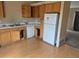 Functional kitchen featuring laminate floors and lots of cabinets, with an adjacent dining area at 1415 S Pitkin Ct, Aurora, CO 80017