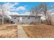 Back exterior of home with patio, small garden, and landscaped backyard at 117 6Th St, Frederick, CO 80530