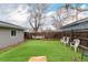 Backyard featuring artificial turf, complemented by a rustic fence and comfortable seating at 117 6Th St, Frederick, CO 80530