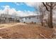 Back exterior of home with patio, small garden, and mature trees in backyard at 117 6Th St, Frederick, CO 80530