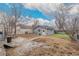 View of detached garage, green grass, patio area, and the home's backyard at 117 6Th St, Frederick, CO 80530