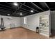 Partially finished basement with exposed ceiling and new vinyl flooring at 117 6Th St, Frederick, CO 80530