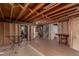 Unfinished basement featuring open rafters and supports, a concrete floor, and exposed utilities at 117 6Th St, Frederick, CO 80530