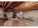 Unfinished basement with exposed ceiling, concrete walls, and an unfinished concrete floor at 117 6Th St, Frederick, CO 80530