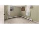 Small bedroom featuring green walls, carpeting and an access door on the left at 117 6Th St, Frederick, CO 80530