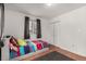 Neutral bedroom featuring hardwood floors, a double closet, and a colorful bed at 117 6Th St, Frederick, CO 80530
