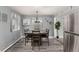 Modern dining area featuring neutral decor with a wooden table and gray walls, adjacent to the kitchen at 117 6Th St, Frederick, CO 80530