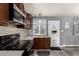 Well-appointed kitchen with dark wood cabinets, stainless appliances, and stylish backsplash, and plenty of light at 117 6Th St, Frederick, CO 80530