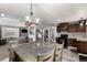 Open concept kitchen and dining area featuring gray and wood finishes, stainless appliances, and modern lighting at 117 6Th St, Frederick, CO 80530
