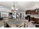 Charming kitchen featuring a dining table with pendant lighting and stainless steel appliances at 117 6Th St, Frederick, CO 80530