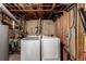 Laundry room featuring a new washer and dryer, exposed pipes and concrete walls at 117 6Th St, Frederick, CO 80530