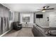 Bright living room features a comfortable grey chair, large window, and a mounted TV for relaxing at 117 6Th St, Frederick, CO 80530