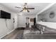 Comfortable living room with large sectional sofa, ceiling fan, and neutral color palette at 117 6Th St, Frederick, CO 80530