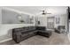 Spacious living room features a comfortable black sofa and modern decor, perfect for relaxation at 117 6Th St, Frederick, CO 80530