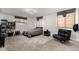 Large carpeted main bedroom with seating area and two windows at 117 6Th St, Frederick, CO 80530