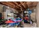 Cluttered storage room featuring shelving, exposed beams, and concrete walls at 117 6Th St, Frederick, CO 80530