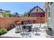 A charming backyard offers a cozy seating area, enclosed by a wooden fence for privacy at 8272 E 55Th Pl, Denver, CO 80238