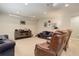 Finished basement with a projection screen, media center, and comfortable seating at 8272 E 55Th Pl, Denver, CO 80238