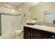 Bathroom featuring a vanity with dark wood cabinets, a shower, and mosaic tile accents at 8272 E 55Th Pl, Denver, CO 80238