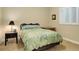 Inviting bedroom featuring neutral walls, a bed, and a window with plantation shutters at 8272 E 55Th Pl, Denver, CO 80238