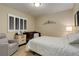 Cozy bedroom with a crib, comfortable chair, and soft lighting at 8272 E 55Th Pl, Denver, CO 80238