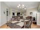Open concept dining area with modern chandelier and seamless flow to living spaces at 8272 E 55Th Pl, Denver, CO 80238
