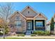 Charming single Gathering home with stone accents, inviting front porch, and well-maintained landscaping at 8272 E 55Th Pl, Denver, CO 80238