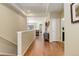 Open hallway with hardwood floors, neutral tones, and seamless transition to living spaces at 8272 E 55Th Pl, Denver, CO 80238