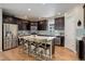 Modern kitchen with stainless steel appliances, center island, and ample cabinet space at 8272 E 55Th Pl, Denver, CO 80238