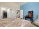 Comfortable bedroom featuring closet and calming blue accent wall at 8272 E 55Th Pl, Denver, CO 80238