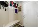 Convenient mudroom featuring a built-in bench, coat hooks, and ample storage for outdoor gear at 8272 E 55Th Pl, Denver, CO 80238