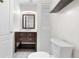This bathroom provides a wooden vanity, mirror, and white commode at 8164 S York Ct, Centennial, CO 80122