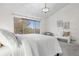 Bright bedroom with a large window, neutral decor, and a cozy seating area at 8164 S York Ct, Centennial, CO 80122