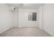 Neutral bedroom with light carpet, large window, white walls, and base trim at 8164 S York Ct, Centennial, CO 80122