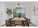 Elegant dining room with a chandelier, large window, and a rustic wooden table at 8164 S York Ct, Centennial, CO 80122