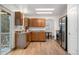 Spacious kitchen with wood cabinetry, stainless steel appliances, and wood-look tile flooring at 8164 S York Ct, Centennial, CO 80122