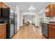 Open kitchen leading to living area with wood floors, stainless refrigerator and lots of natural light at 8164 S York Ct, Centennial, CO 80122