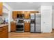Well-equipped kitchen with stainless steel appliances and wood cabinets with granite counters at 8164 S York Ct, Centennial, CO 80122