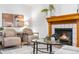 Inviting living room with a cozy fireplace, modern decor, and comfortable seating for relaxed gatherings at 8164 S York Ct, Centennial, CO 80122
