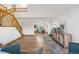 Open-concept room featuring hardwood floors, a two-story window, stylish decor and an open staircase at 8164 S York Ct, Centennial, CO 80122