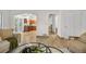 Bright and airy living room featuring wood floors, white walls and arched doorways to the kitchen and hallway at 8164 S York Ct, Centennial, CO 80122