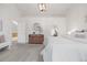 Bright main bedroom featuring plush carpet, a contemporary chandelier and a decorative sideboard at 8164 S York Ct, Centennial, CO 80122
