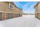 Attached garages with snow covered driveway at 18152 E Flora Pl # D, Aurora, CO 80013