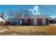 Well-kept single-story home showcasing a classic brick design and manicured lawn under a beautiful sky at 4602 Biscay St, Denver, CO 80249