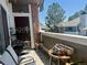 Relax on this comfortable balcony featuring partial shade, plants, and patio furniture at 14353 E 1St Dr # 302, Aurora, CO 80011