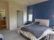 Bedroom with en-suite bathroom, blue accent wall, and large window at 14353 E 1St Dr # 302, Aurora, CO 80011