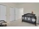 The room features a crib, closets with doors, and a ceiling light at 14353 E 1St Dr # 302, Aurora, CO 80011