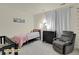 This bedroom is complete with a daybed, crib, recliner, and dresser perfect for a Bedroom at 14353 E 1St Dr # 302, Aurora, CO 80011